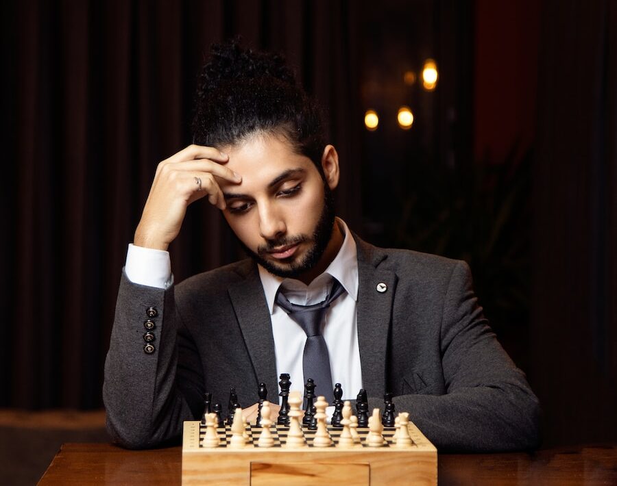 a man wearing a suit and tie sitting at a table