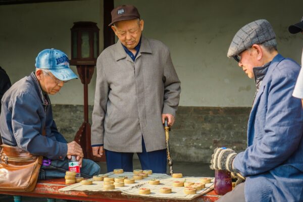 a group of men playing a game of checkers