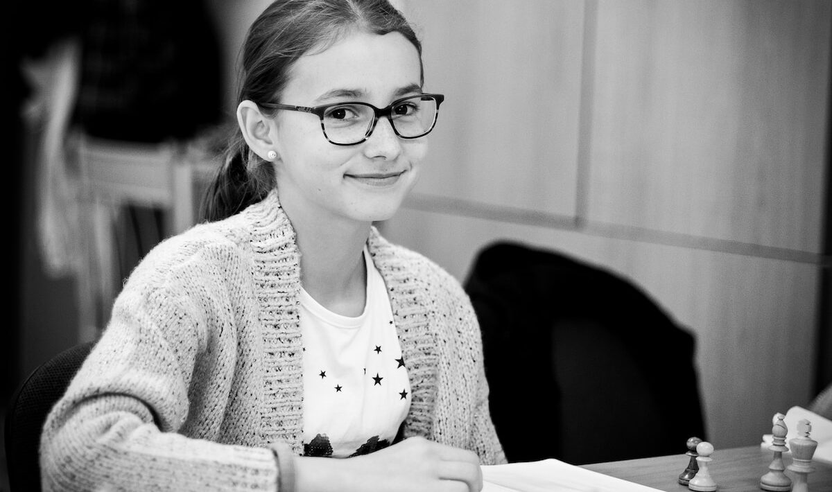 grayscale photo of girl playing chess