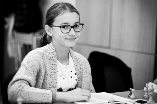 grayscale photo of girl playing chess