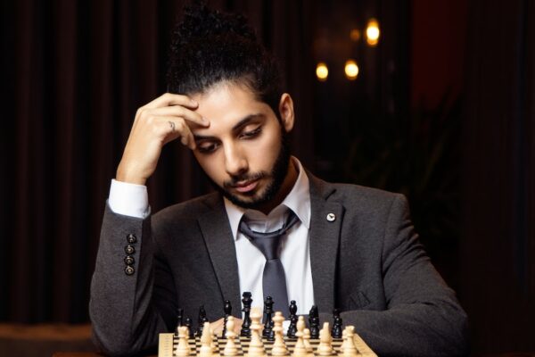 a man wearing a suit and tie sitting at a table