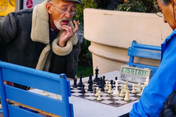 man in blue jacket sitting on blue chair